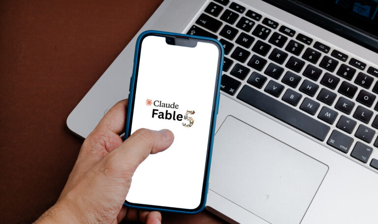 Smartphone displaying the Claude Fable interface next to a laptop, representing AI-assisted storytelling, content creation, and business productivity.